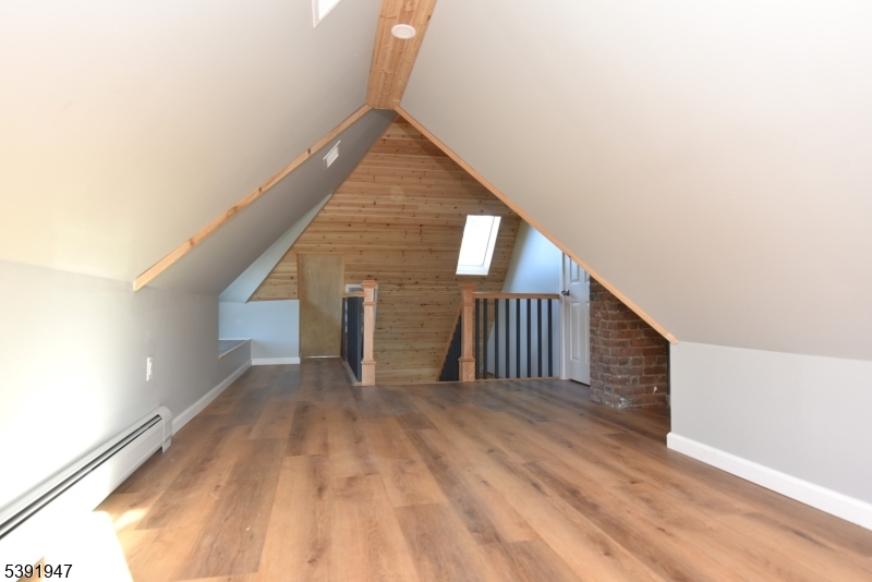 454 Park Avenue Rutherford, NJ 07070 - Photo 20 of 27 a view of a hallway with wooden floor and stairs