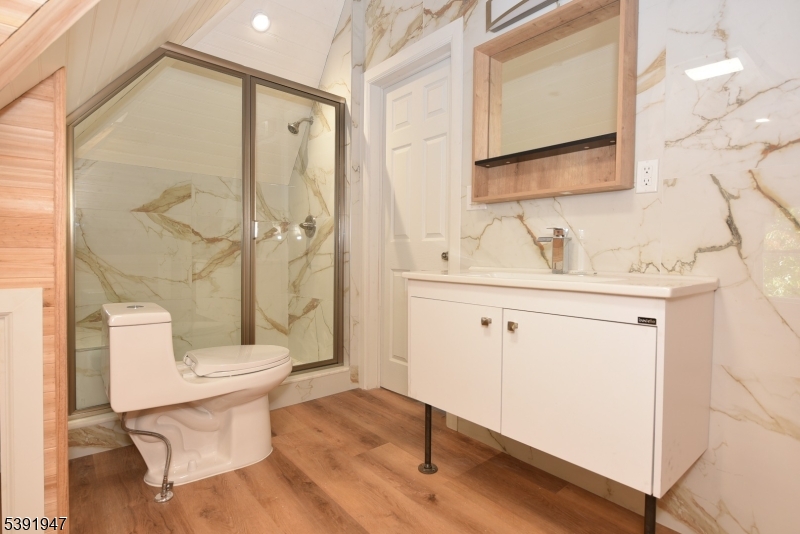 454 Park Avenue Rutherford, NJ 07070 - Photo 23 of 27 a bathroom with a sink toilet a mirror and shower