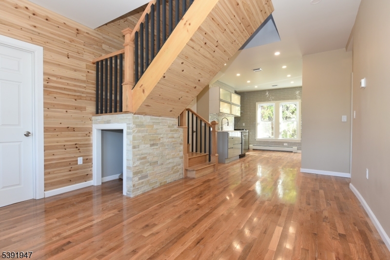 454 Park Avenue Rutherford, NJ 07070 - Photo 5 of 27 a view of empty room with wooden floor and fireplace