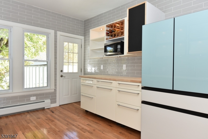 454 Park Avenue Rutherford, NJ 07070 - Photo 9 of 27 a kitchen with stainless steel appliances cabinets and a large window