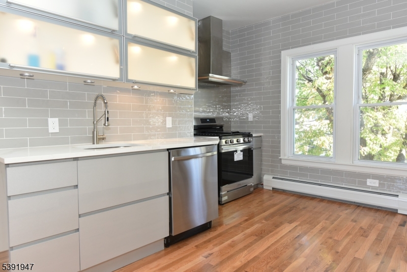 454 Park Avenue Rutherford, NJ 07070 - Photo 10 of 27 a kitchen with stainless steel appliances a stove a sink and a large window