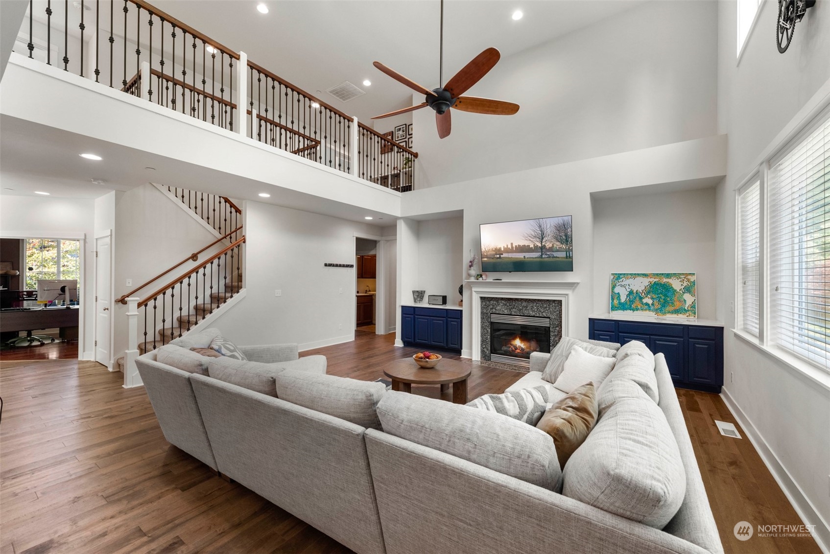 22201 32nd Avenue Southeast Bothell, WA 98021 - Photo 4 of 39 a living room with furniture a fireplace and a ceiling fan