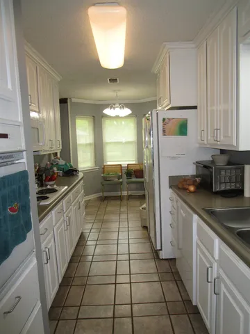 a kitchen with stainless steel appliances granite countertop a sink and cabinets