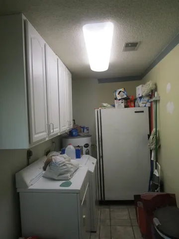 a view of a storage and utility room with a sink