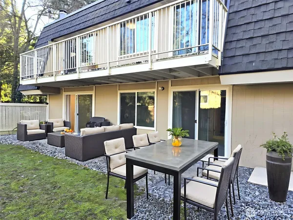 a view of a patio with table and chairs and potted plants