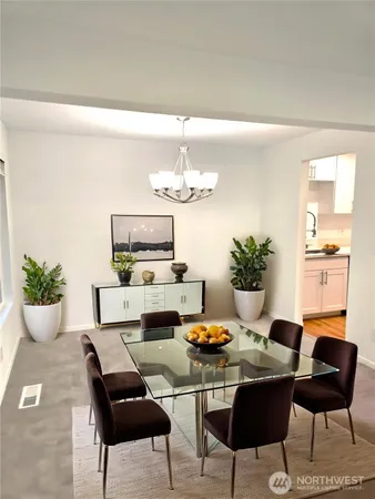 a dining room with furniture and chandelier