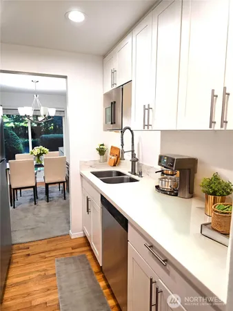 a kitchen with sink refrigerator and stove