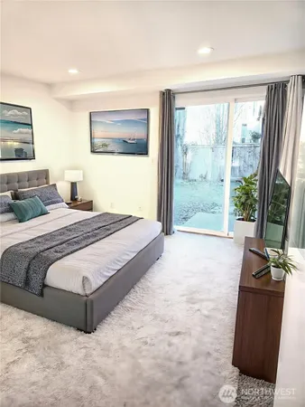 a bedroom with a large bed and a large window