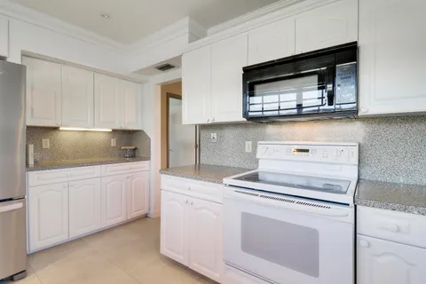 a kitchen with stainless steel appliances a sink stove and cabinets