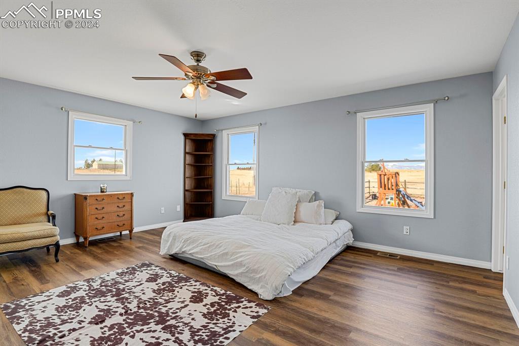 3805 Curtis Road Peyton, CO 80831 - Photo 11 of 36 a bedroom with a bed furniture and wooden floor