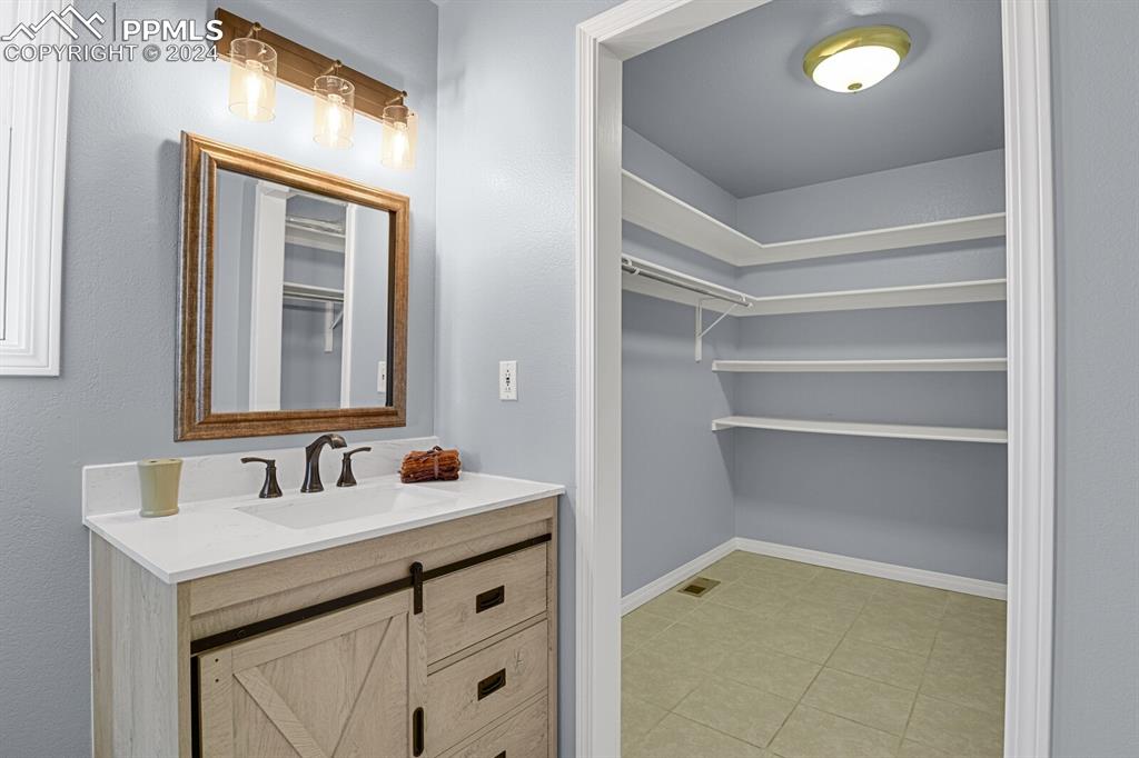 3805 Curtis Road Peyton, CO 80831 - Photo 12 of 36 a bathroom with a sink and a mirror