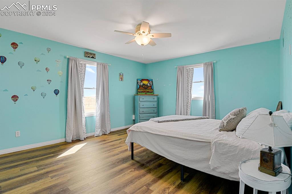 3805 Curtis Road Peyton, CO 80831 - Photo 13 of 36 a bedroom with a bed and a chandelier