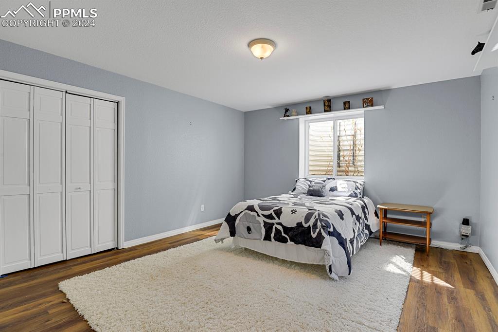 3805 Curtis Road Peyton, CO 80831 - Photo 19 of 36 a bed sitting in a bedroom next to a window