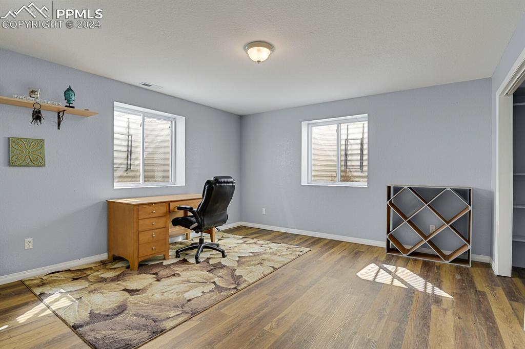 3805 Curtis Road Peyton, CO 80831 - Photo 20 of 36 a work room with furniture and wooden floor