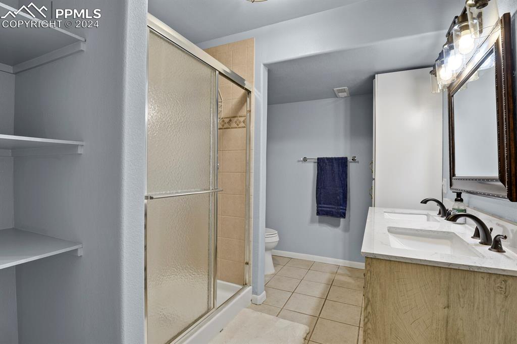 3805 Curtis Road Peyton, CO 80831 - Photo 21 of 36 a bathroom with a sink and a mirror