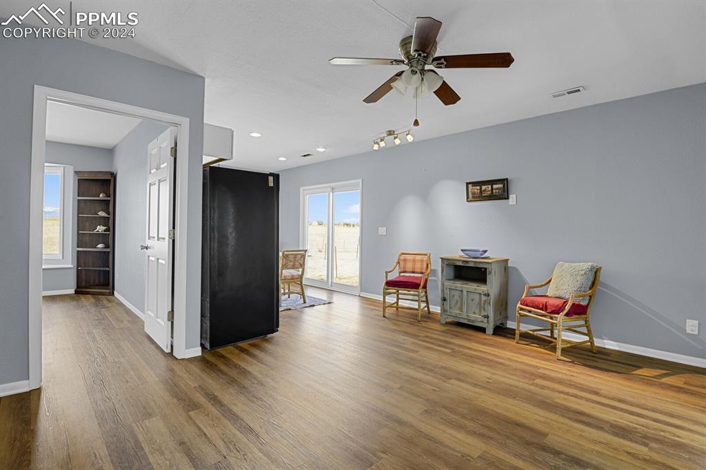 3805 Curtis Road Peyton, CO 80831 - Photo 22 of 36 a living room with furniture and a wooden floor