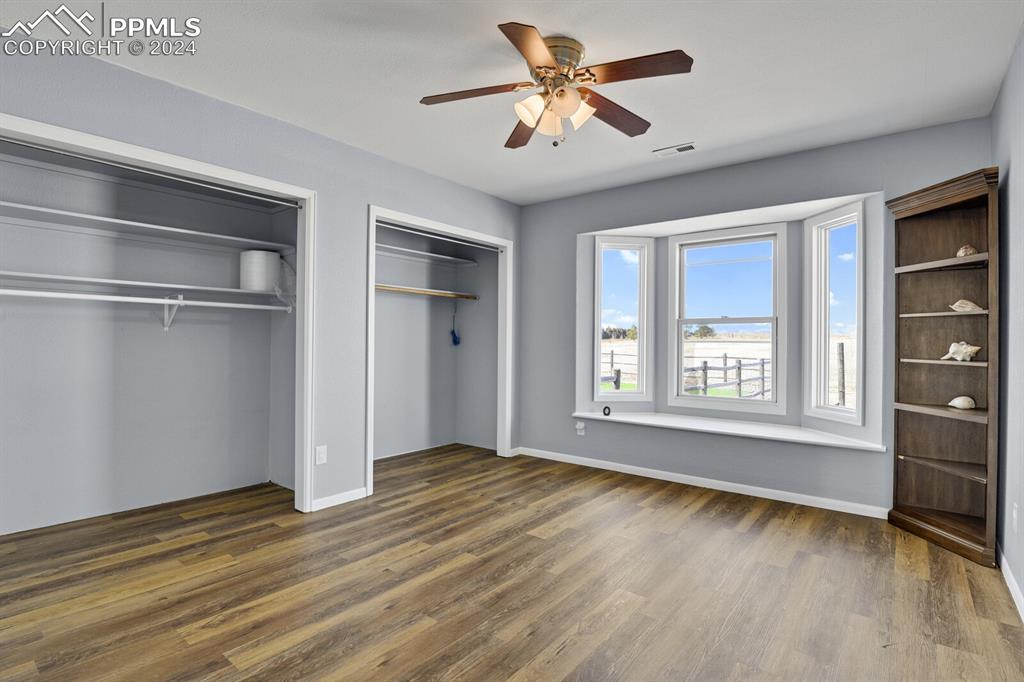 3805 Curtis Road Peyton, CO 80831 - Photo 24 of 36 a view of an empty room with a window and wooden floor