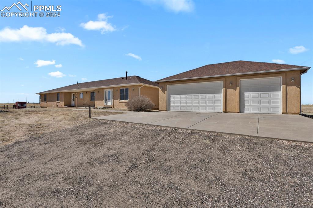 3805 Curtis Road Peyton, CO 80831 - Photo 32 of 36 a front view of a house with large trees