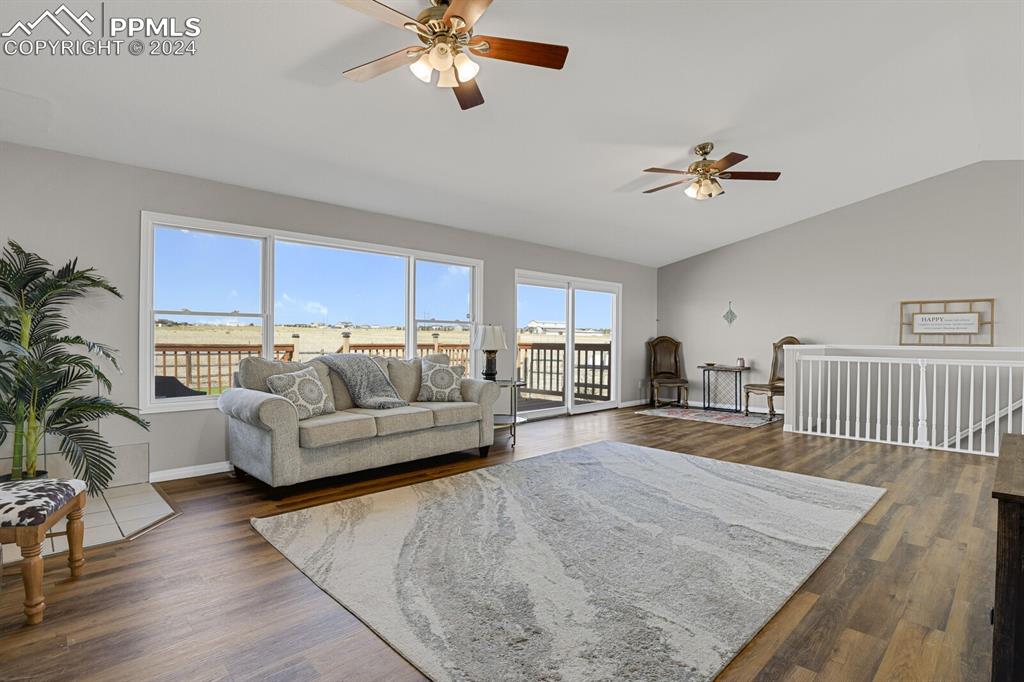 3805 Curtis Road Peyton, CO 80831 - Photo 4 of 36 a living room with furniture and a wooden floor