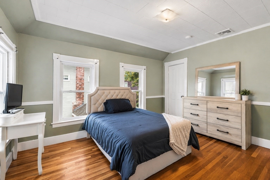 4 State Street, Unit 4 Milford, MA 01757 - Photo 14 of 23 a bedroom with a bed and a flat screen tv