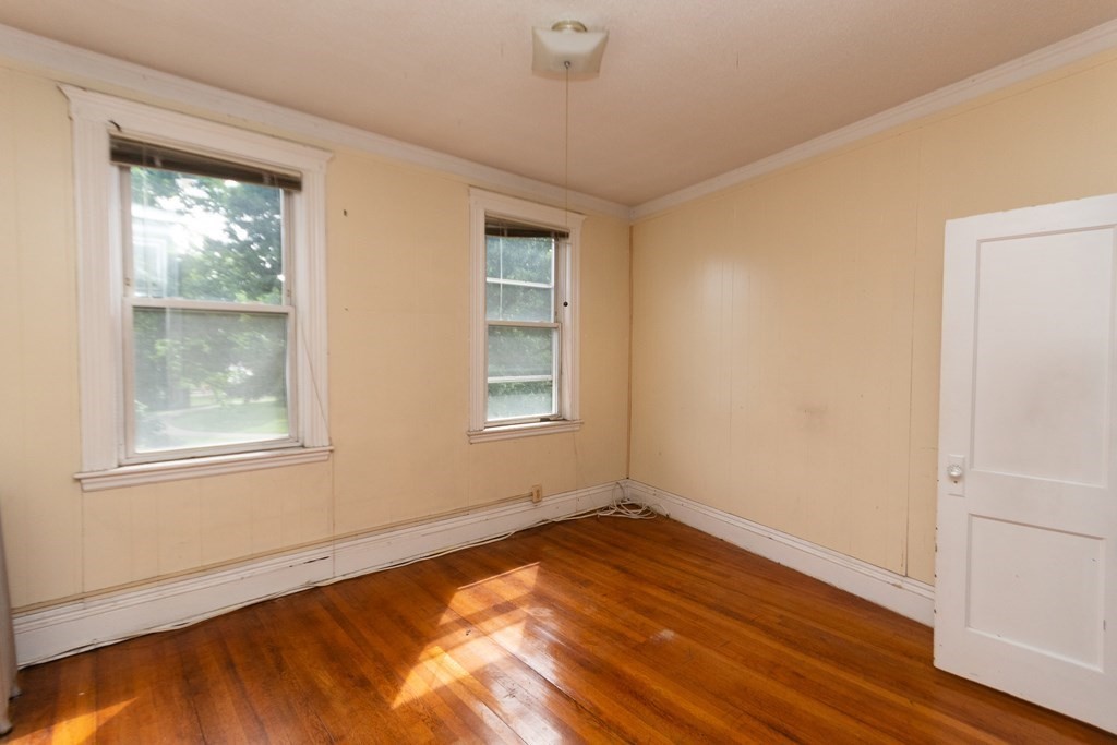 88 Winthrop Street Boston, MA 02119 - Photo 14 of 20 a view of an empty room with wooden floor and a window