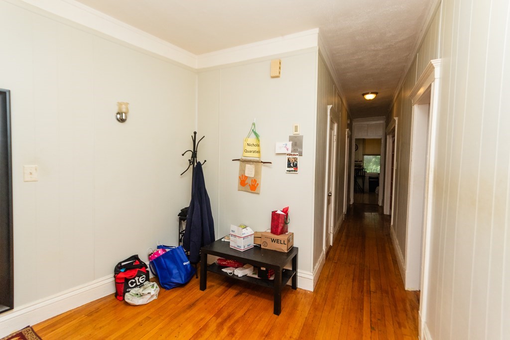 88 Winthrop Street Boston, MA 02119 - Photo 4 of 20 a living room with furniture and a wooden floor
