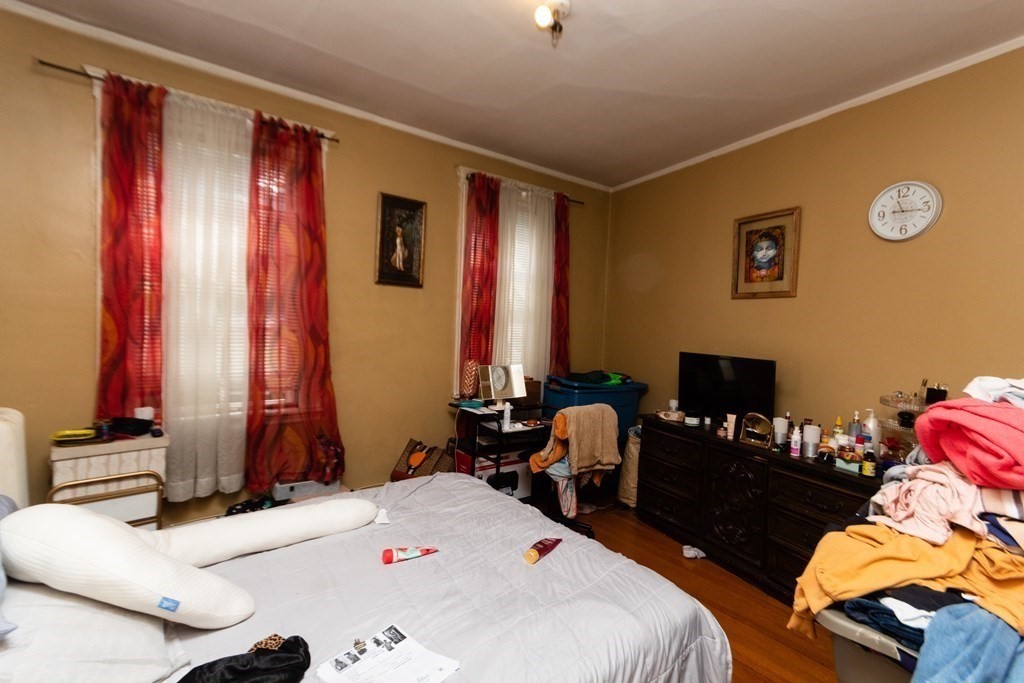 88 Winthrop Street Boston, MA 02119 - Photo 10 of 20 a bedroom with a bed and a window