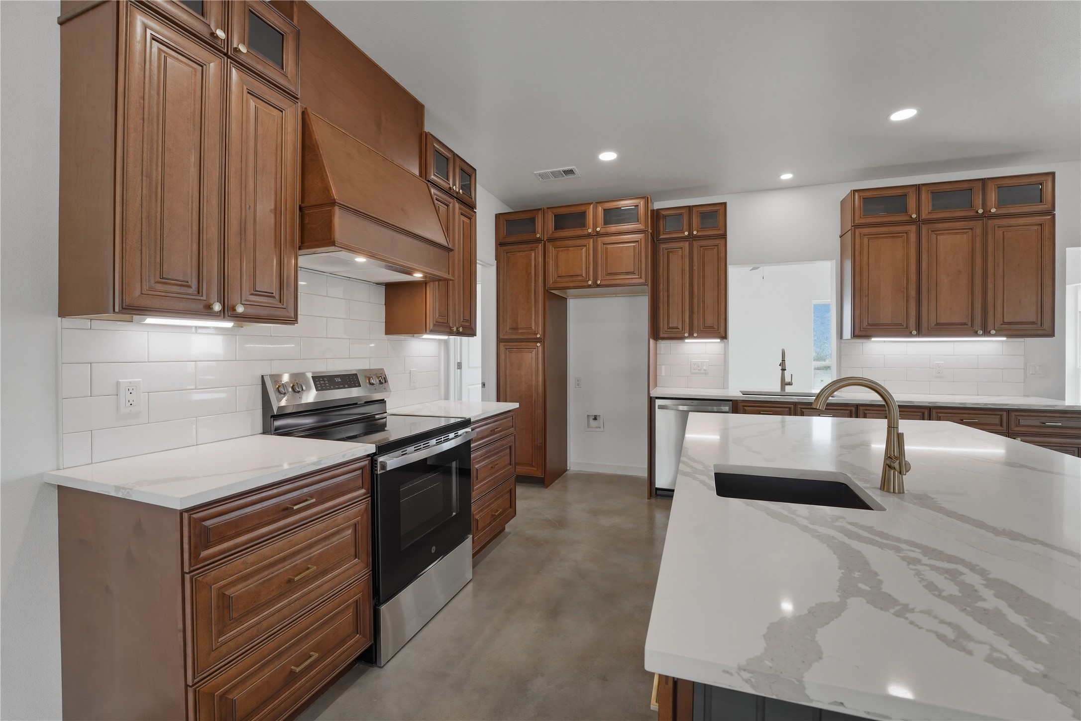 9345 Hajovsky Road La Grange, TX 78945 - Photo 3 of 24 a kitchen with stainless steel appliances granite countertop a sink stove and refrigerator