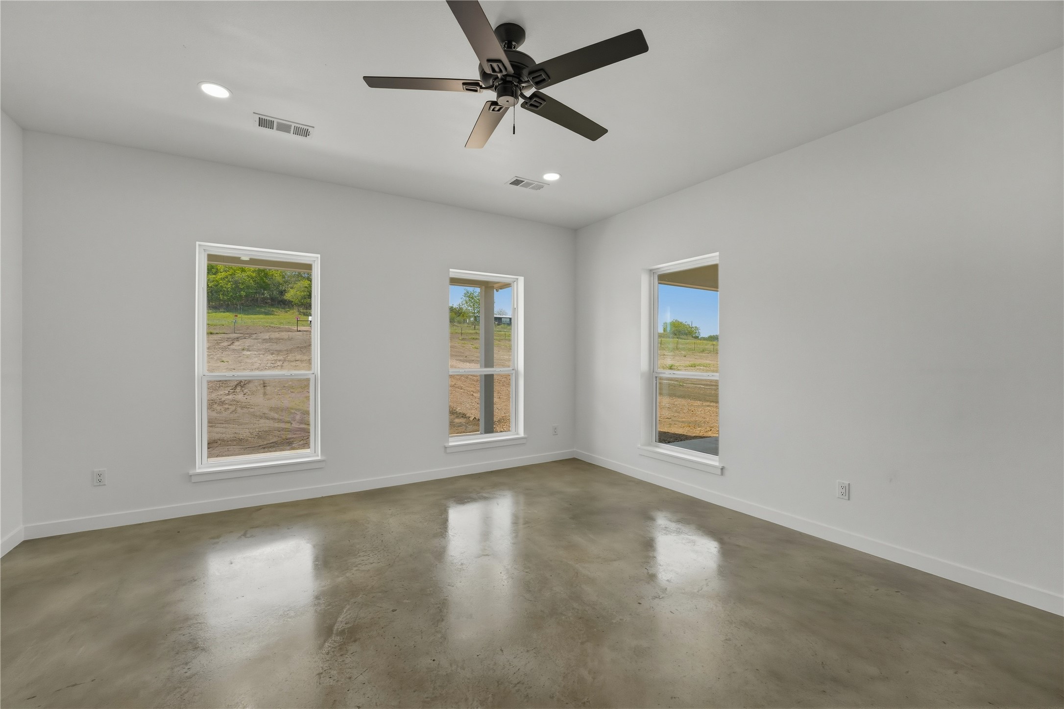 9345 Hajovsky Road La Grange, TX 78945 - Photo 7 of 24 a view of an empty room with a window and wooden floor