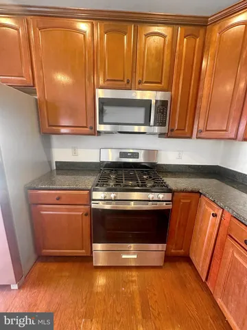 a stove top oven sitting inside of a kitchen