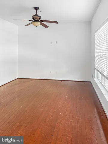 a view of room with hardwood floor and window
