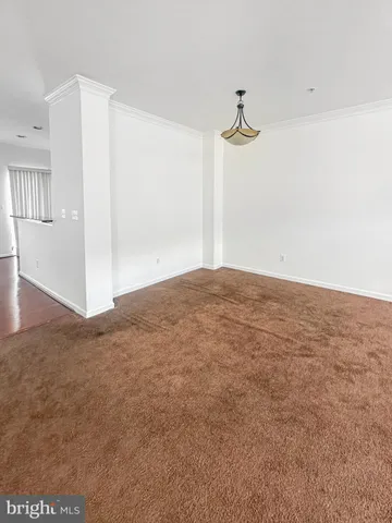 an empty room with closet and a chandelier fan