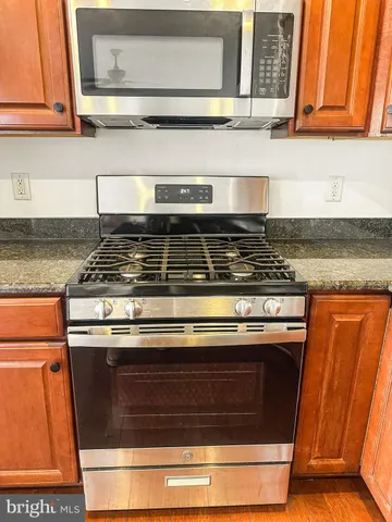 a stove top oven sitting inside of a kitchen