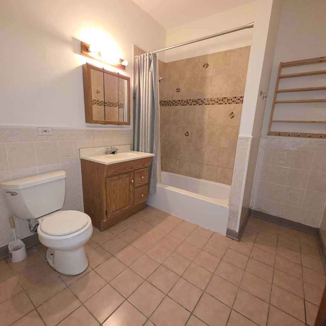 3224 West Armitage Avenue, Unit 2 Chicago, IL 60647 - Photo 11 of 12 a bathroom with a sink a toilet and shower