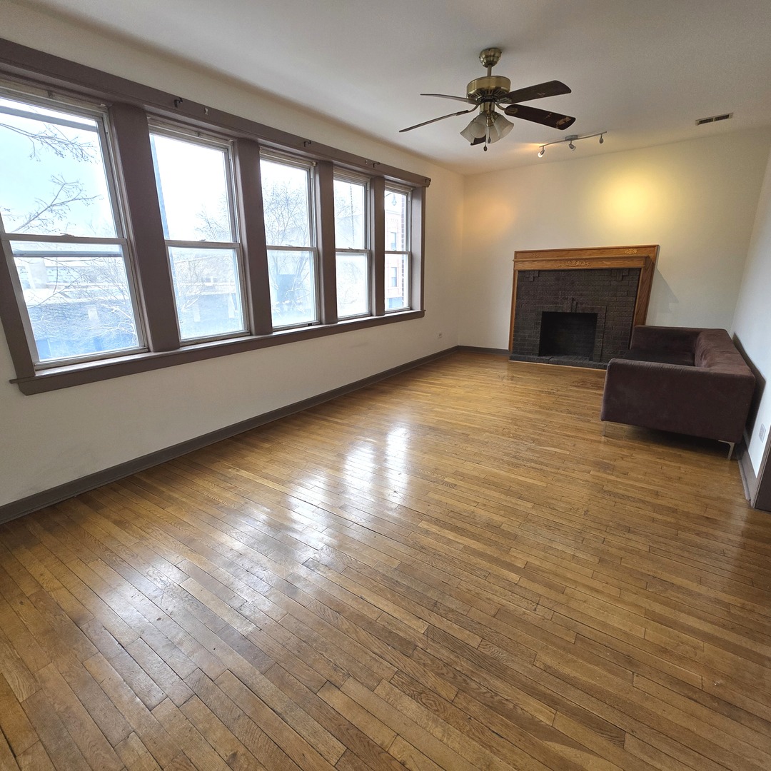 3224 West Armitage Avenue, Unit 2 Chicago, IL 60647 - Photo 2 of 12 a view of an empty room with a window and a kitchen