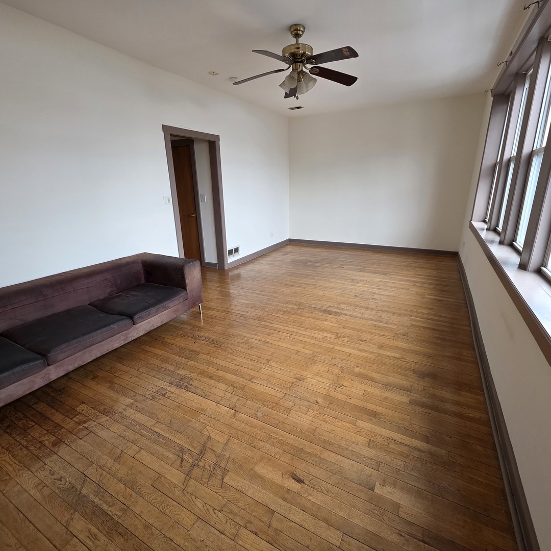 3224 West Armitage Avenue, Unit 2 Chicago, IL 60647 - Photo 3 of 12 wooden floor in an empty room with a window