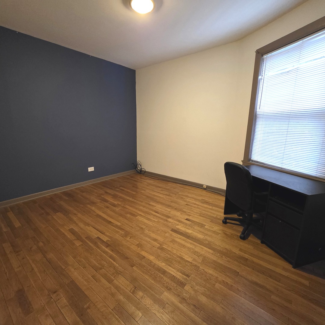 3224 West Armitage Avenue, Unit 2 Chicago, IL 60647 - Photo 8 of 12 an empty room with wooden floor and a window