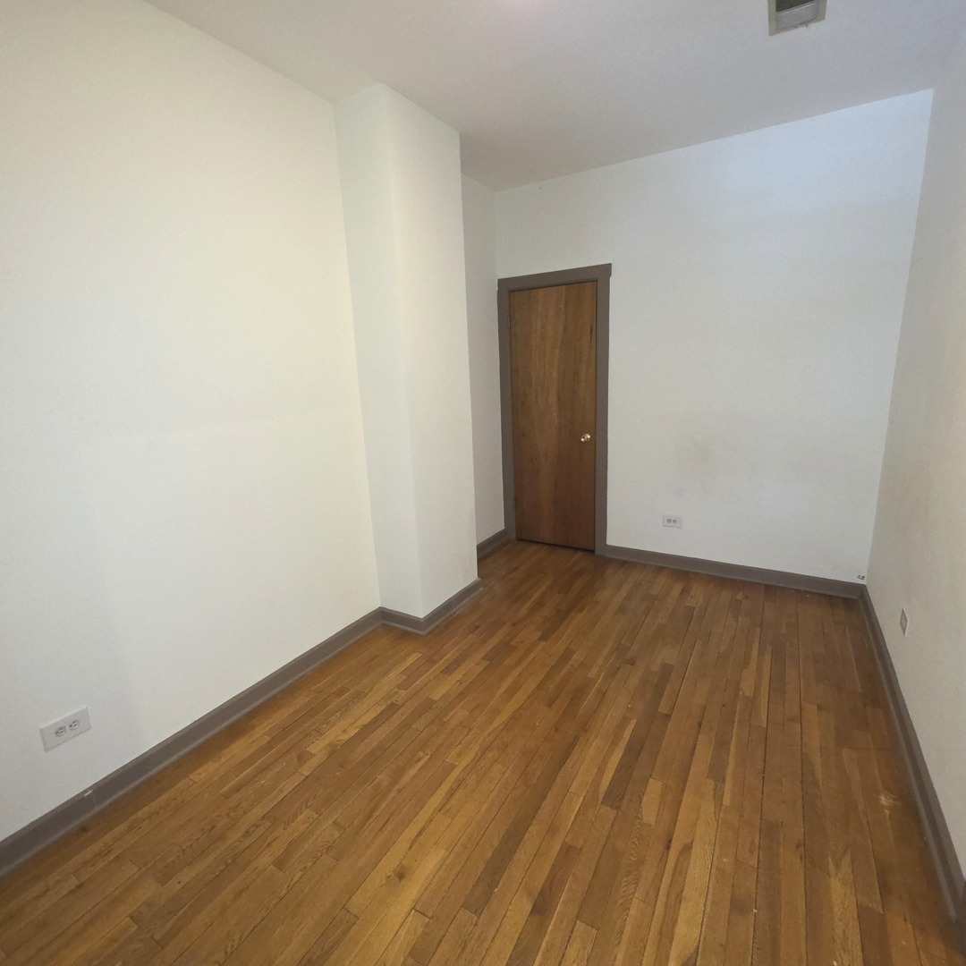 3224 West Armitage Avenue, Unit 2 Chicago, IL 60647 - Photo 10 of 12 a view of an empty room with wooden floor and closet