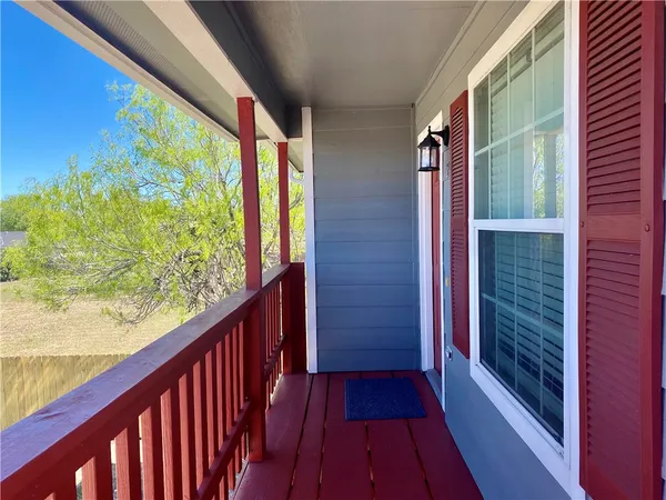 a view of balcony with wooden floor