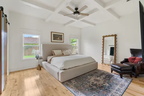 a spacious bedroom with a bed a couch and a window