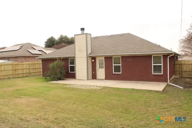 a front view of a house with a garden and yard