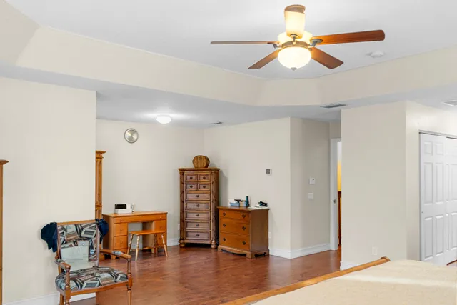 a view of a livingroom with furniture and a ceiling fan