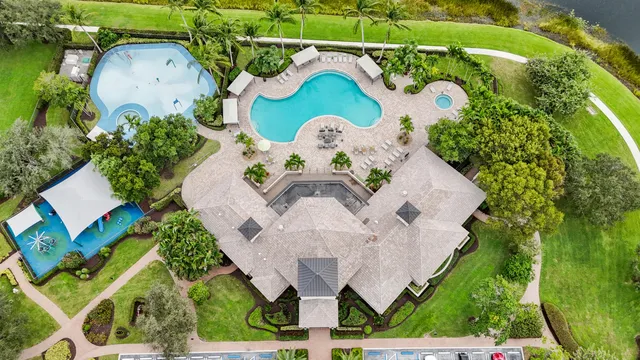 an aerial view of a house with a yard and lake view