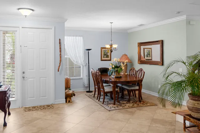 a view of a dining room with furniture and a potted plant