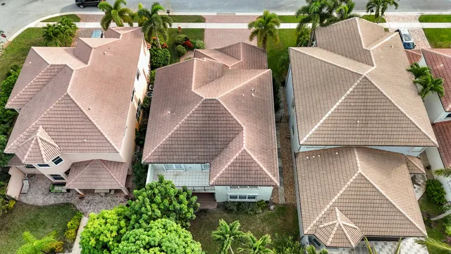 an aerial view of a house with a yard and potted plants