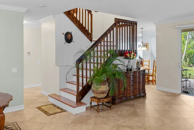 a view of staircase with a rug and a window