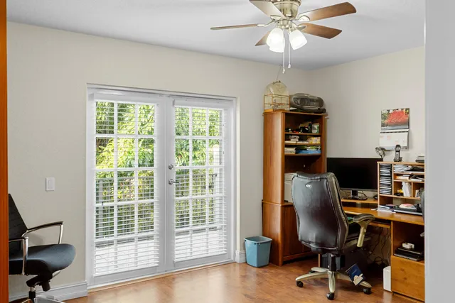 a view of a workspace with furniture and a window