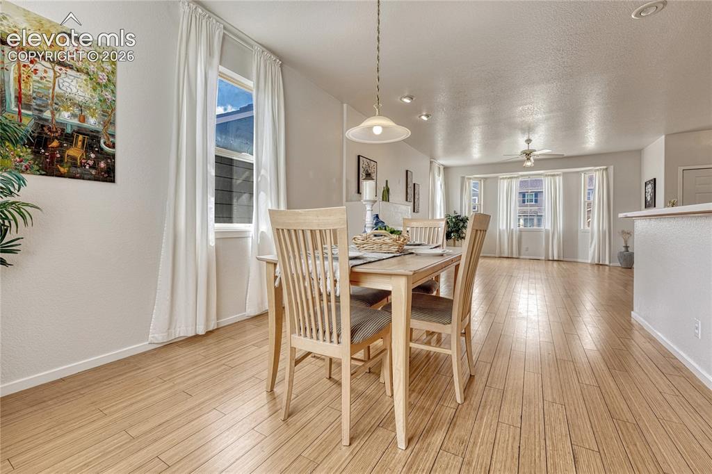 7285 Julynn Road Colorado Springs, CO 80919 - Photo 10 of 45 a view of a dining room with furniture window and wooden floor