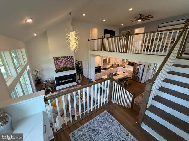 a view of a hallway with wooden floor and windows