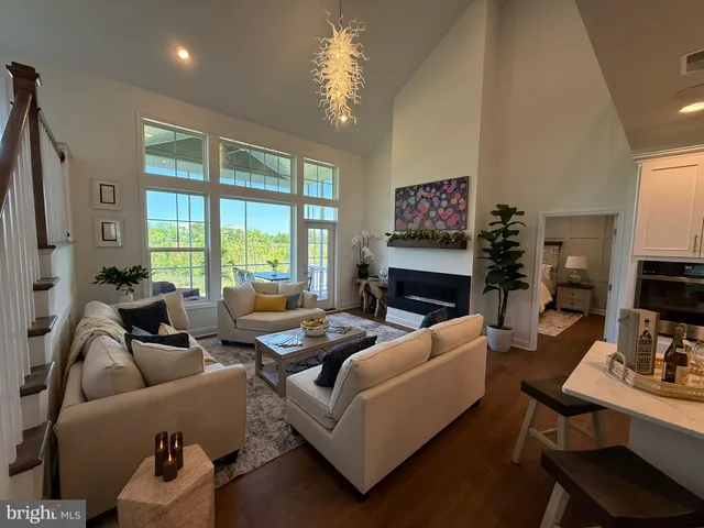 a living room with furniture fireplace and a large window
